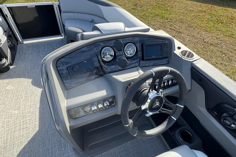 Slide: The Image of 2026 Tahoe Pontoon LTZ Quad Lounger 23 dashboard with modern controls and steering wheel. - 7