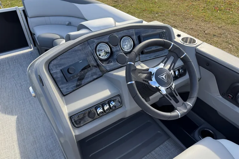 Slide: The Image of 2026 Tahoe Pontoon LTZ Quad Lounger 23 dashboard with modern steering wheel and controls. - 8