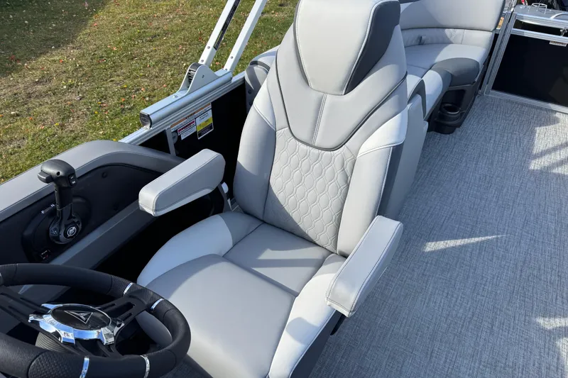 Slide: The Image of 2026 Tahoe Pontoon LTZ Quad Lounger 23 captain's chair and steering wheel detail. - 9