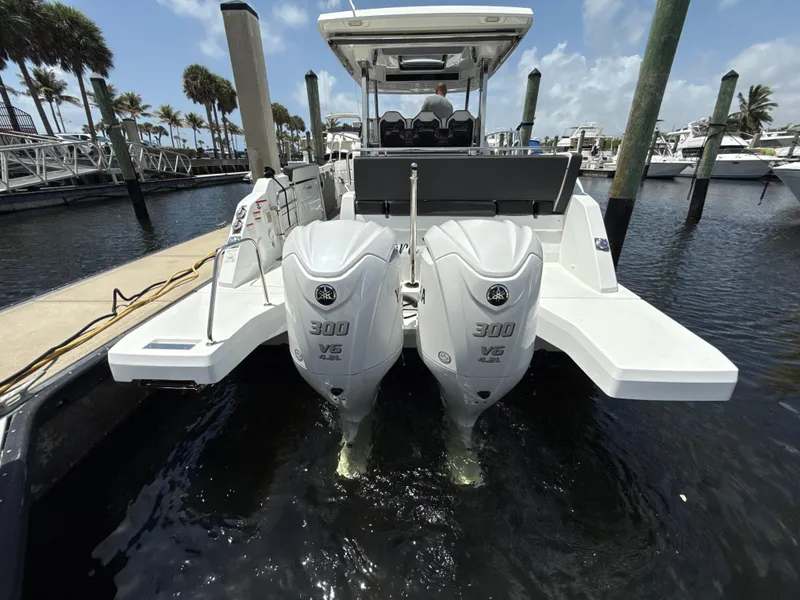 Slide: The Image of 2022 Jeanneau Leader 10.5 WA Series 2 with twin Yamaha 300 V6 engines docked at marina. - 10