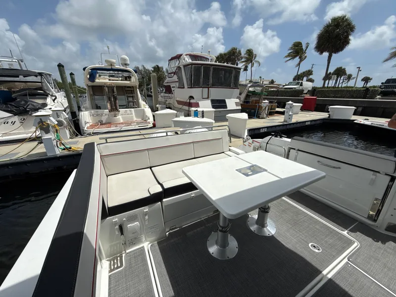 Slide: The Image of 2022 Jeanneau Leader 10.5 WA Series 2 docked, featuring spacious seating and table. - 14