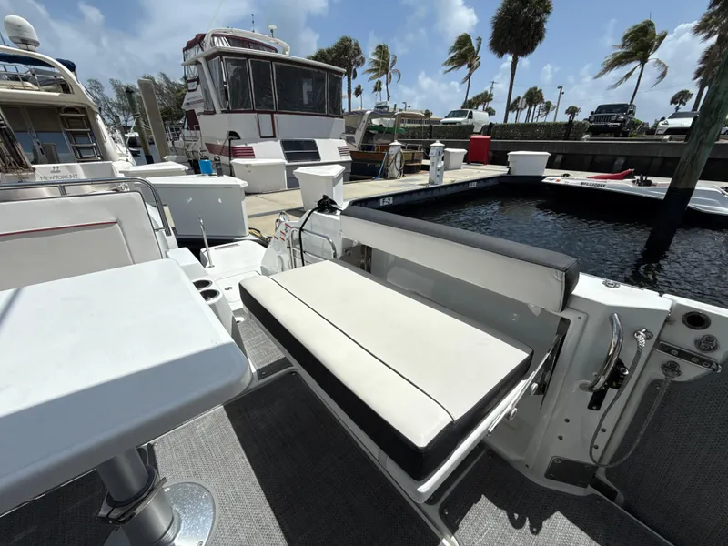 Slide: The Image of 2022 Jeanneau Leader 10.5 WA Series 2 boat docked, featuring seating and table. - 15