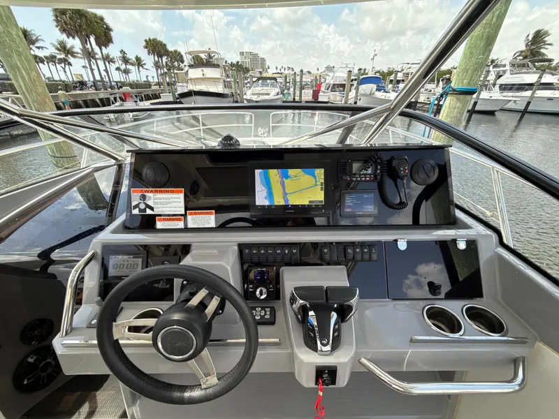 Slide: The Image of Helm of 2022 Jeanneau Leader 10.5 WA Series 2 with navigation display and controls. - 18