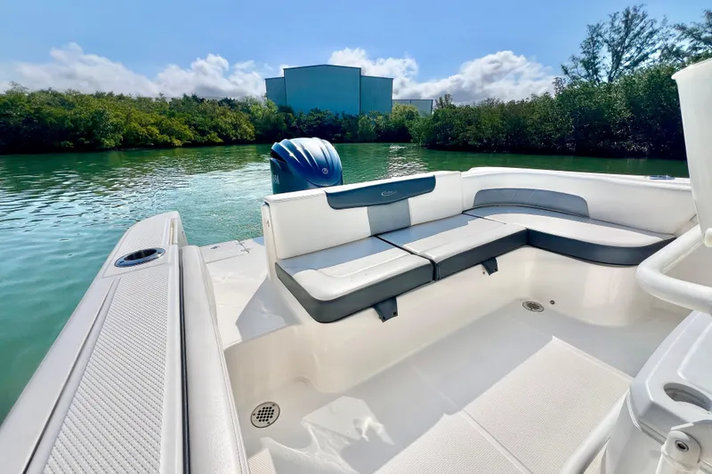 Slide: The Image of 2021 Robalo R242 Explorer boat interior with seating, on a serene waterway. - 12
