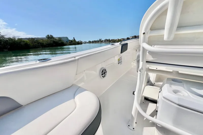 Slide: The Image of 2021 Robalo R242 Explorer boat interior with seating and water view. - 14