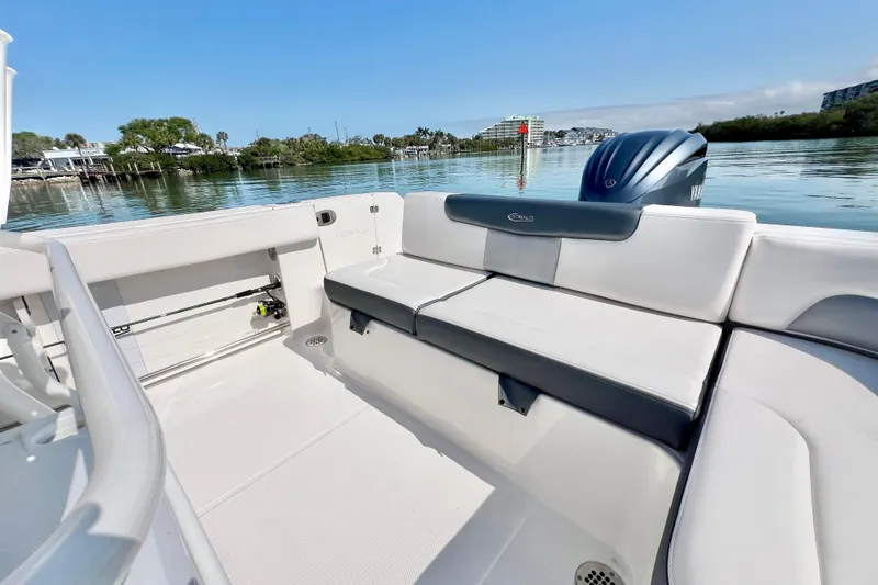 Slide: The Image of 2021 Robalo R242 Explorer boat interior with seating, on calm water. - 16