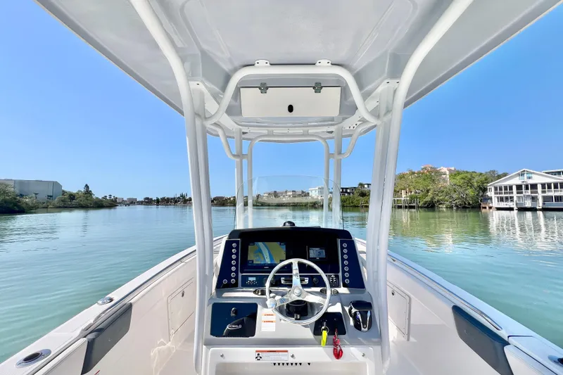 Slide: The Image of 2021 Robalo R242 Explorer boat dashboard with scenic waterfront view. - 17