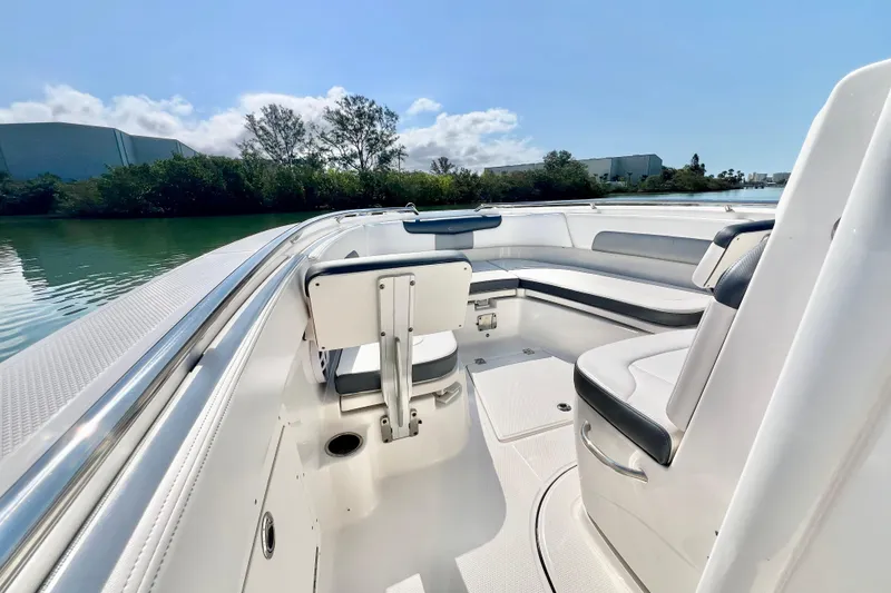 Slide: The Image of 2021 Robalo R242 Explorer boat interior with sleek seating and scenic water view. - 20