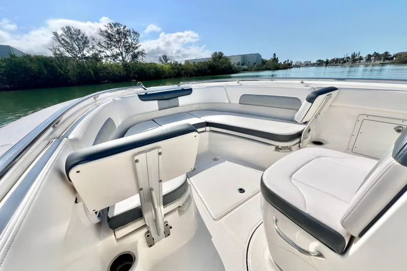 Slide: The Image of 2021 Robalo R242 Explorer boat interior with white seating and scenic water view. - 21