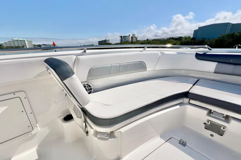 Slide: The Image of 2021 Robalo R242 Explorer boat interior with cushioned seating and scenic water view. - 22