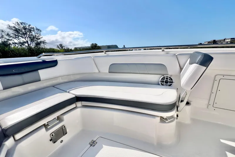 Slide: The Image of 2021 Robalo R242 Explorer boat interior with cushioned seating and speaker. - 24