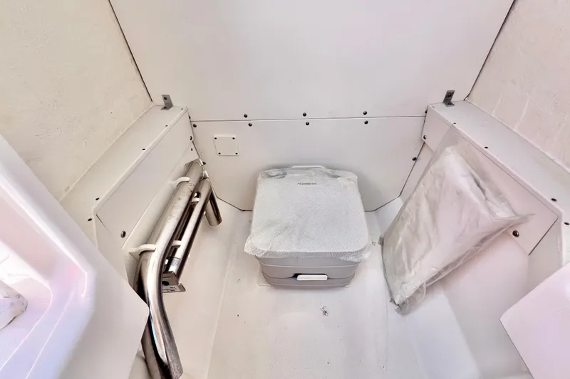 Slide: The Image of 2021 Robalo R242 Explorer interior with portable toilet and storage space. - 29
