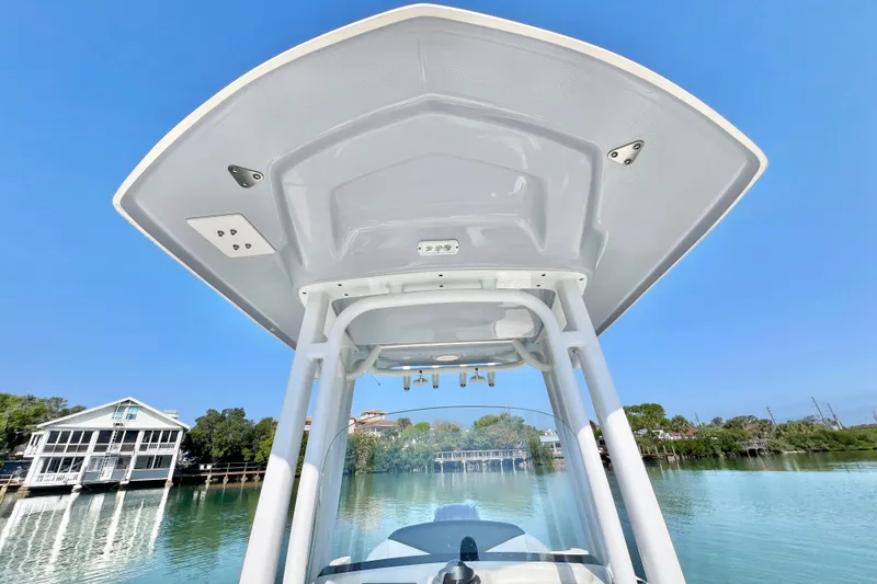 Slide: The Image of 2021 Robalo R242 Explorer boat canopy with scenic waterfront view. - 30