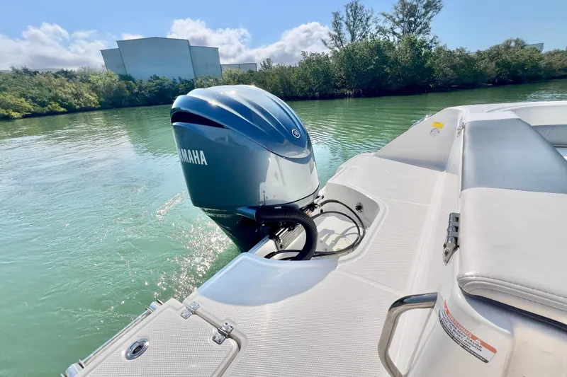 Slide: The Image of 2021 Robalo R242 Explorer with Yamaha outboard engine on calm water. - 8