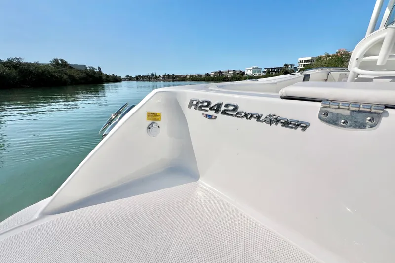 Slide: The Image of 2021 Robalo R242 Explorer boat on calm water, showcasing sleek design and branding. - 9