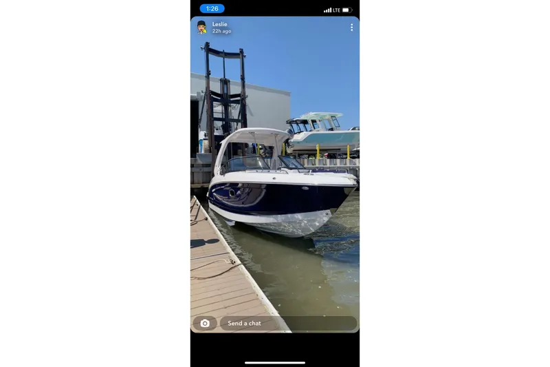 The Image of 2021 Chaparral 317 SSX boat docked at marina under clear blue sky. - 0