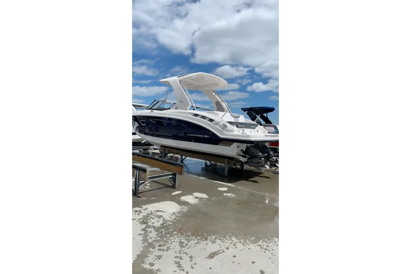 Slide: The Image of 2021 Chaparral 317 SSX boat on a dock under a blue sky. - 1