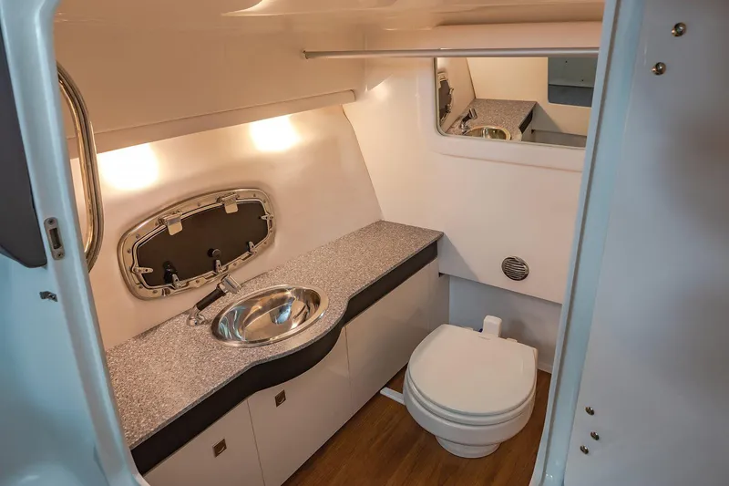 Slide: The Image of Manufacturer Provided Image: 2021 Chaparral 317 SSX boat bathroom with sink, toilet, and countertop. - 13