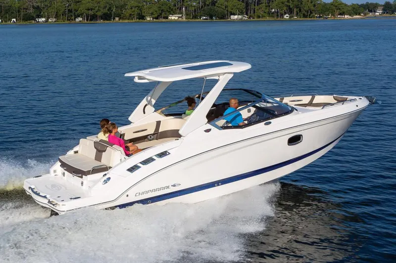 Slide: The Image of Manufacturer Provided Image: 2021 Chaparral 317 SSX boat cruising on a lake with passengers. - 2