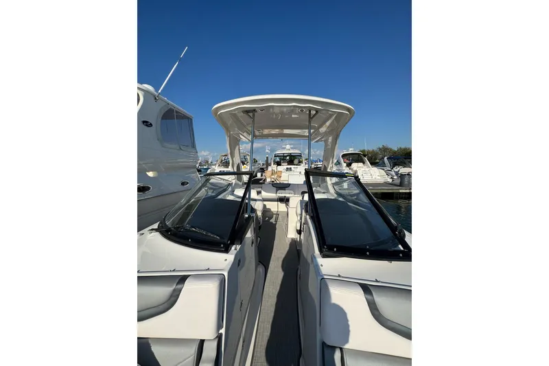 Slide: The Image of 2021 Chaparral 317 SSX boat docked under clear blue sky. - 22