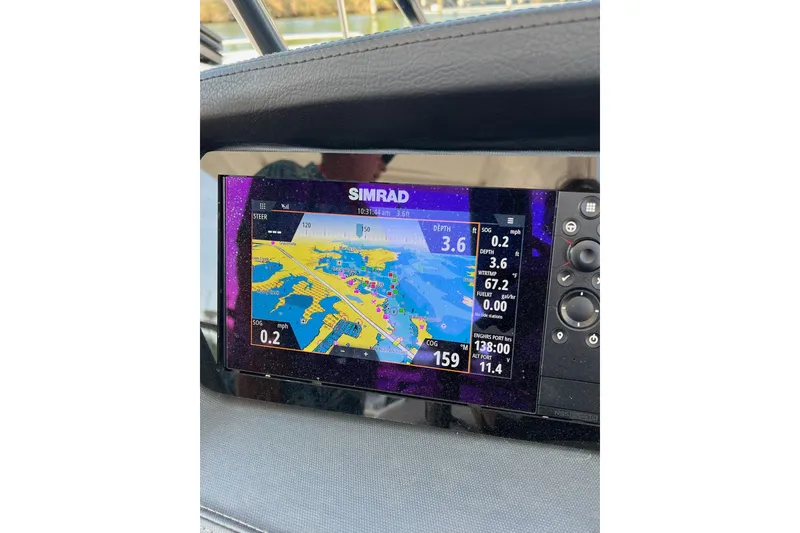 Slide: The Image of Simrad navigation display on 2021 Chaparral 317 SSX boat dashboard. - 27