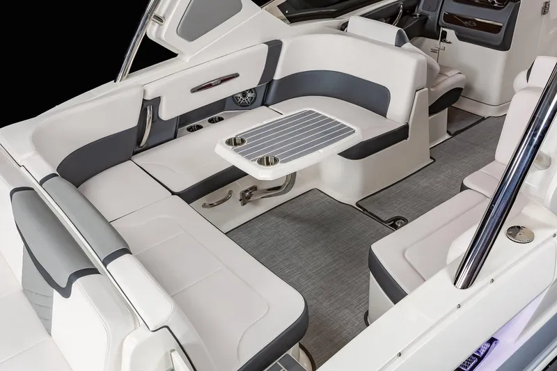 Slide: The Image of Manufacturer Provided Image: 2021 Chaparral 317 SSX boat interior with white and gray seating and table. - 9