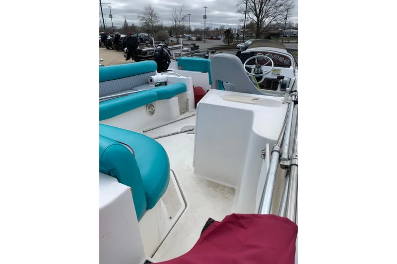 Slide: The Image of 2000 Harris-Kayot 226 Super Deck boat interior with teal seating and steering console. - 2