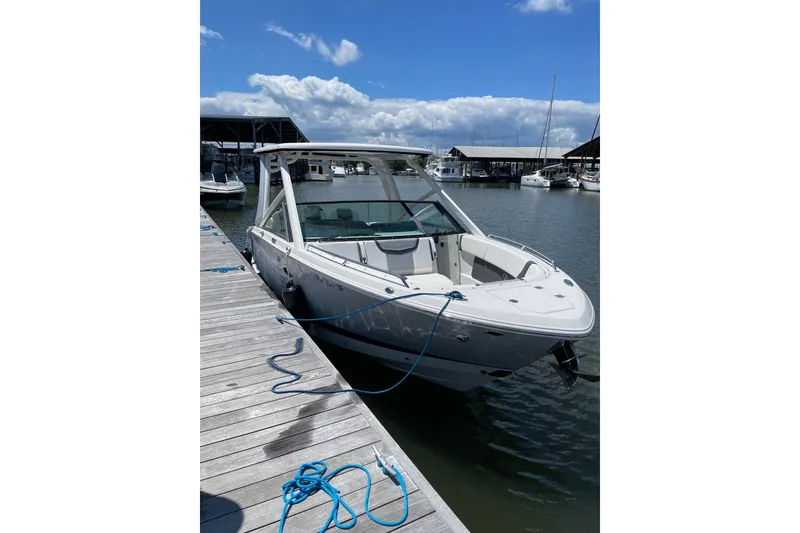 The Image of 2024 Chaparral 280 OSX boat docked at marina under clear blue sky. - 0
