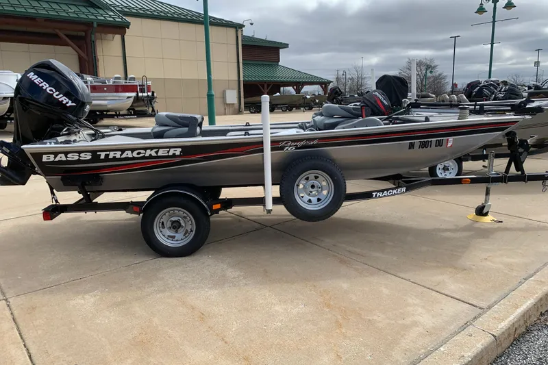 The Image of 2013 Tracker Panfish 16 boat on trailer, featuring Mercury engine, parked outdoors. - 1