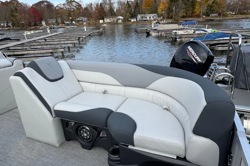 Slide: The Image of 2026 Tahoe Pontoon LTZ Quad Lounger 23 with luxurious seating by a serene lake. - 6