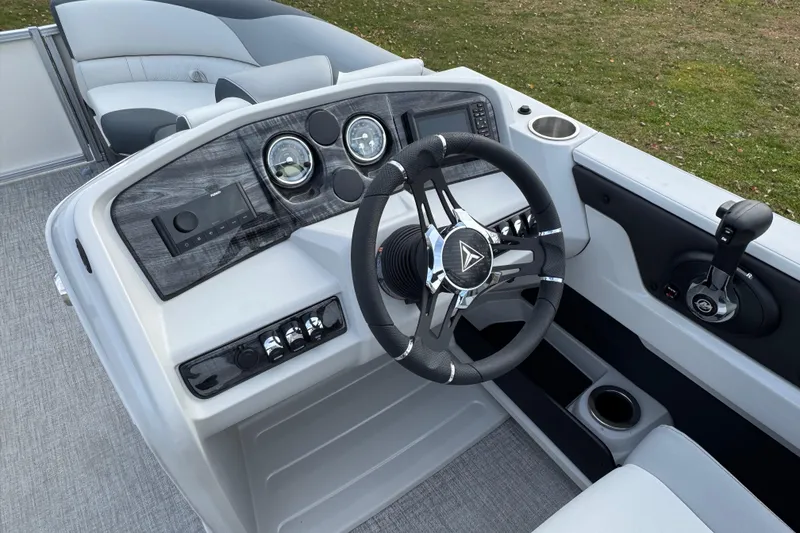 Slide: The Image of 2026 Tahoe Pontoon LTZ Quad Lounger 23 dashboard with modern steering and controls. - 7