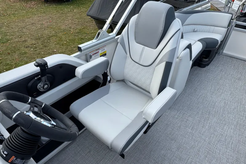 Slide: The Image of 2026 Tahoe Pontoon LTZ Quad Lounger 23 interior with luxurious seating and steering wheel. - 8