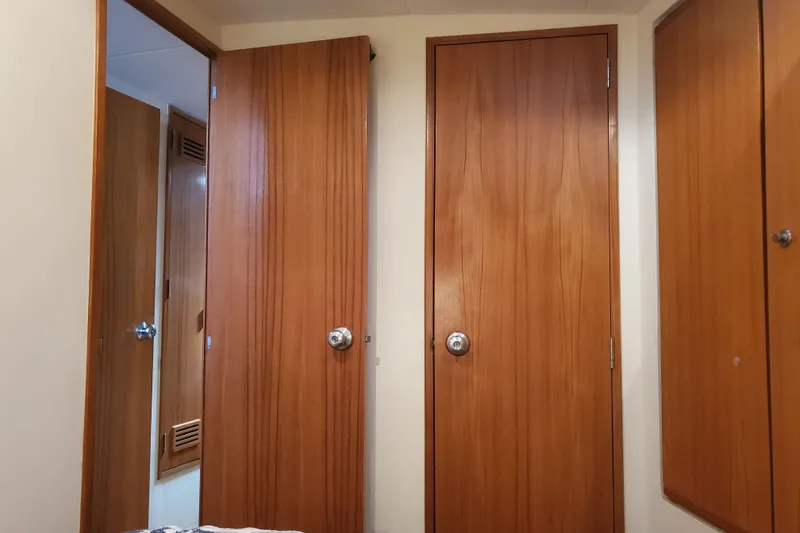 Slide: The Image of Interior view of 1996 Bertram 46 Convertible yacht with wooden doors and cabinetry. - 12