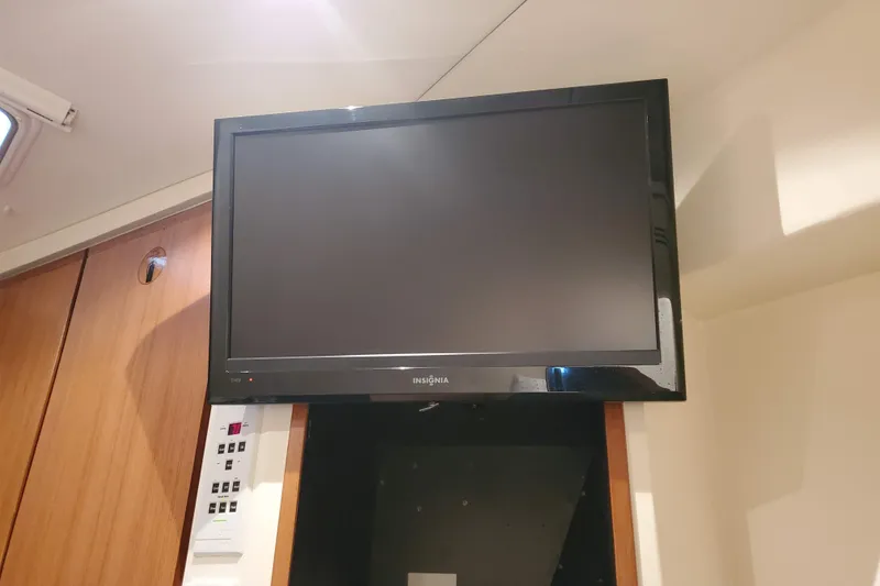 Slide: The Image of Flat-screen TV mounted inside a 1996 Bertram 46 Convertible yacht interior. - 15