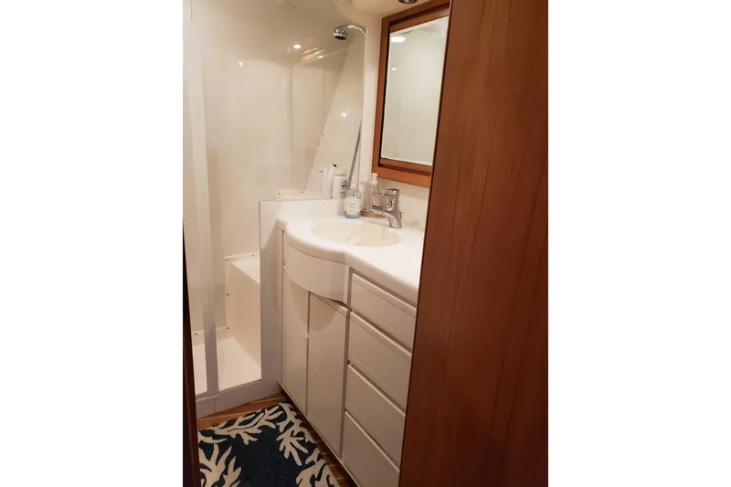 Slide: The Image of Bathroom interior of 1996 Bertram 46 Convertible yacht, featuring sink and shower. - 17