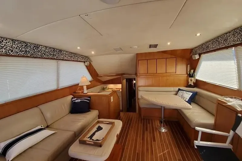 Slide: The Image of Interior of a 1996 Bertram 46 Convertible yacht with elegant seating and wooden flooring. - 22