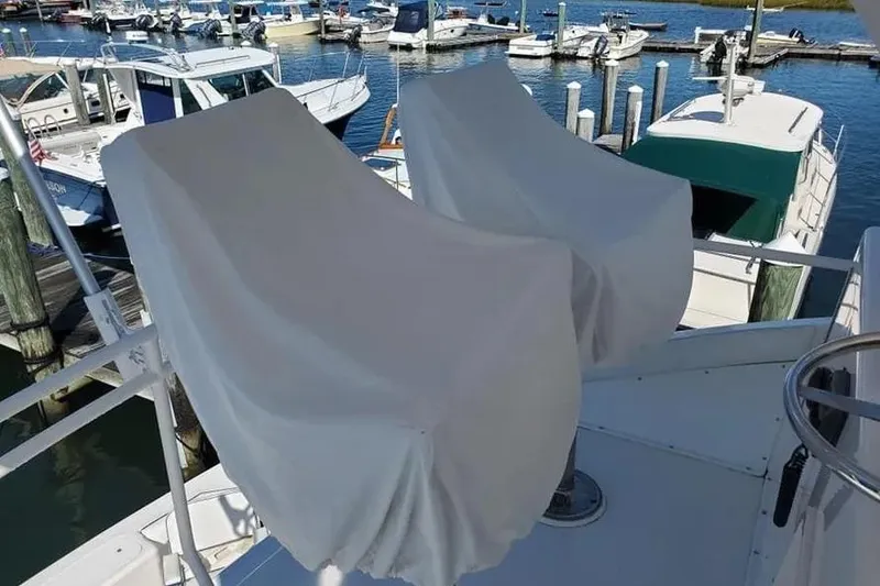 Slide: The Image of Covered seats on a 1996 Bertram 46 Convertible yacht at a marina. - 23