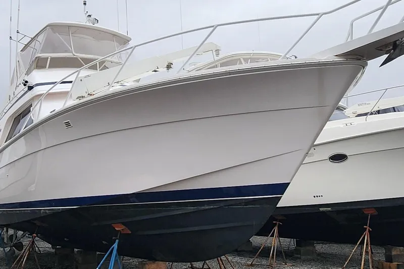 Slide: The Image of 1996 Bertram 46 Convertible yacht on stands, showcasing sleek design and sturdy construction. - 3