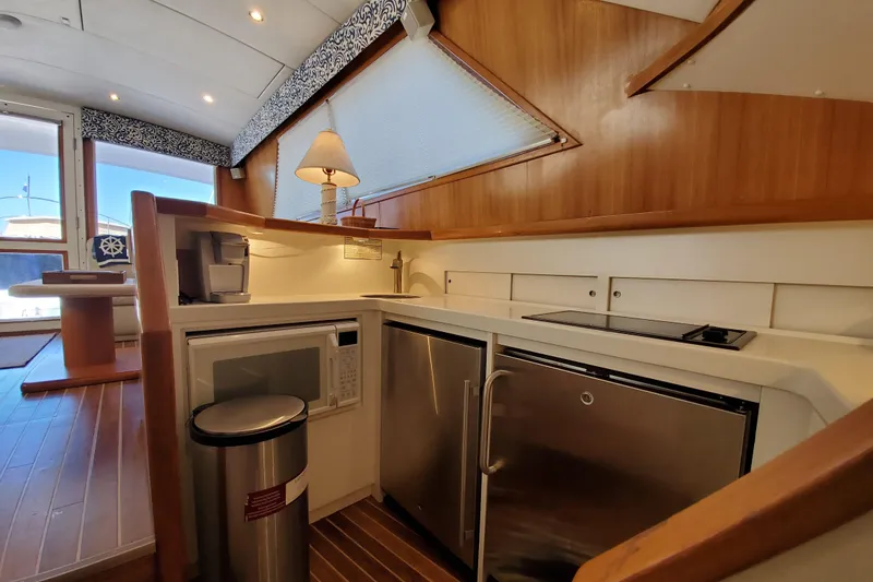 Slide: The Image of Interior of a 1996 Bertram 46 Convertible yacht kitchen with modern appliances. - 7