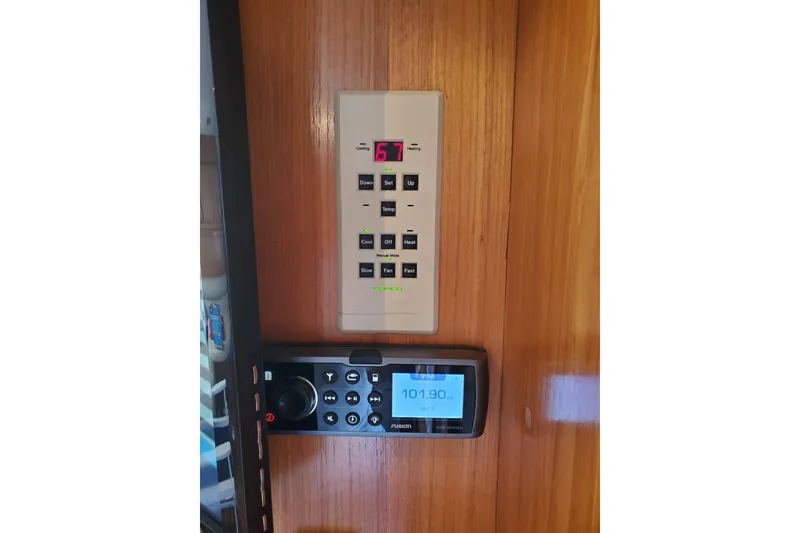 Slide: The Image of Control panel and radio on a 1996 Bertram 46 Convertible yacht interior. - 9