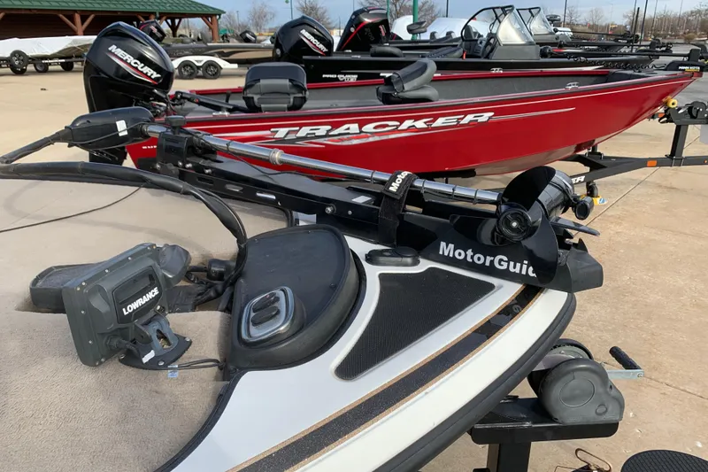 Slide: The Image of 2010 Nitro Z-7 boat with MotorGuide trolling motor and Lowrance fish finder, parked near Tracker boats. - 6