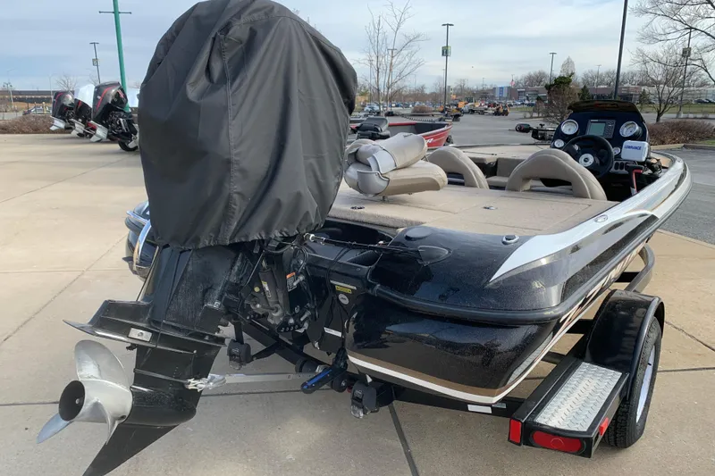 Slide: The Image of 2010 Nitro Z-7 boat with covered outboard motor, parked on a trailer in a lot. - 7