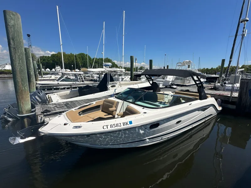 The Image of 2019 Sea Ray SLX 280 boat docked in a marina under clear blue skies. - 0