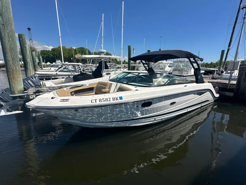 Slide: The Image of 2019 Sea Ray SLX 280 boat docked in marina under clear blue sky. - 1