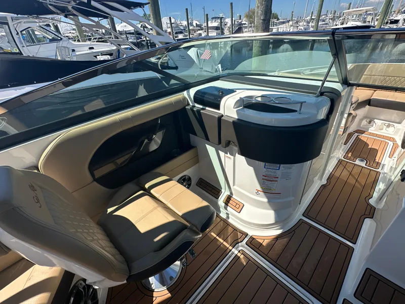 Slide: The Image of 2019 Sea Ray SLX 280 boat interior with luxurious seating and sleek dashboard design. - 15