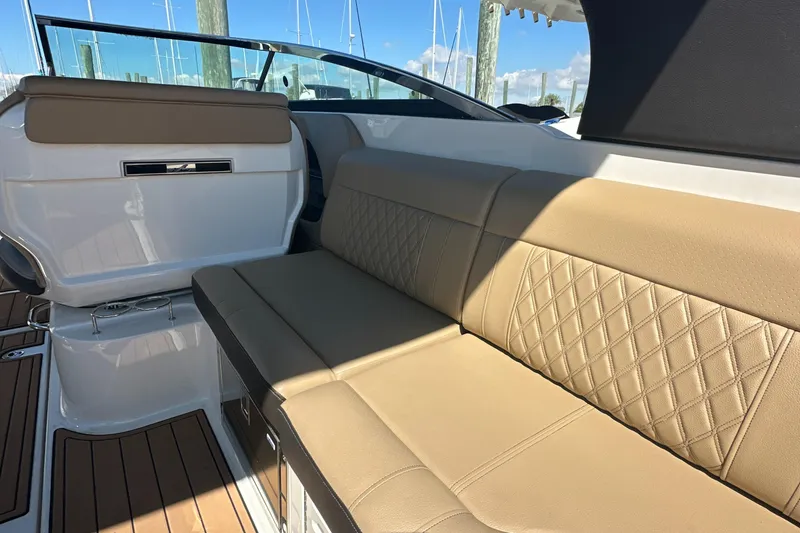 Slide: The Image of 2019 Sea Ray SLX 280 interior with tan leather seating and elegant design. - 16
