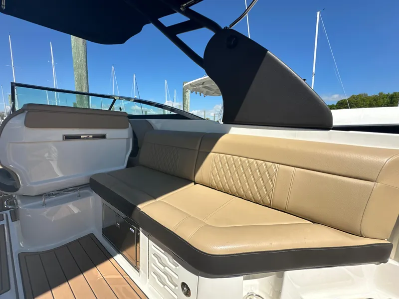Slide: The Image of 2019 Sea Ray SLX 280 boat interior with tan leather seating and sleek design. - 17