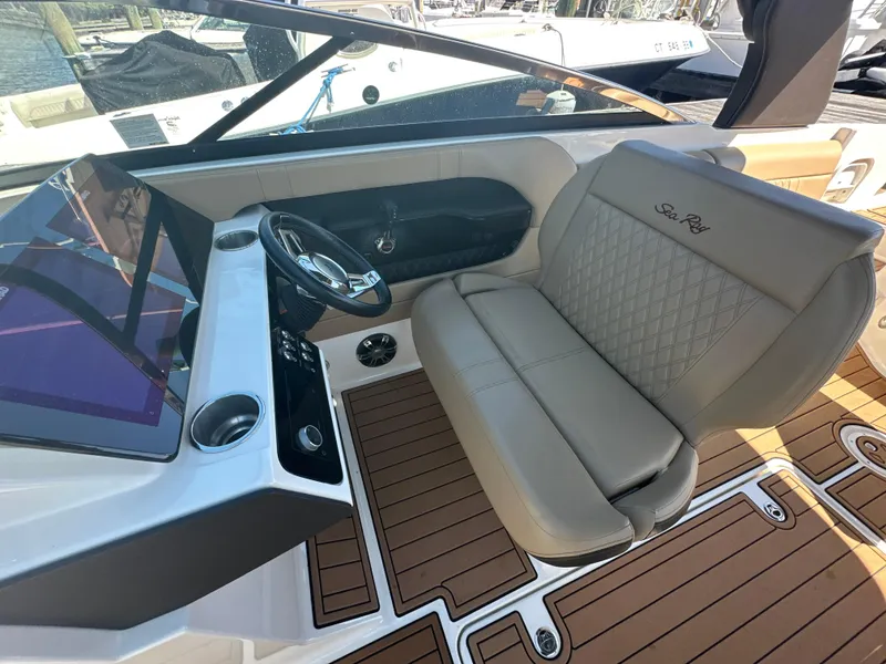 Slide: The Image of 2019 Sea Ray SLX 280 boat interior with leather seating and modern dashboard. - 23