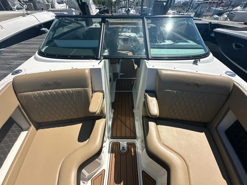 Slide: The Image of 2019 Sea Ray SLX 280 boat interior with tan seating and wood accents. - 33