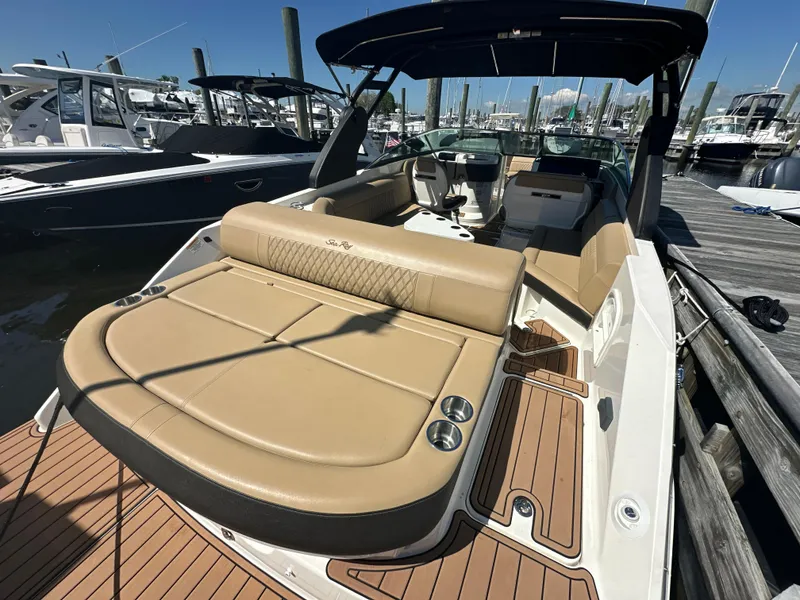 Slide: The Image of 2019 Sea Ray SLX 280 boat with tan seating, docked at a marina. - 40
